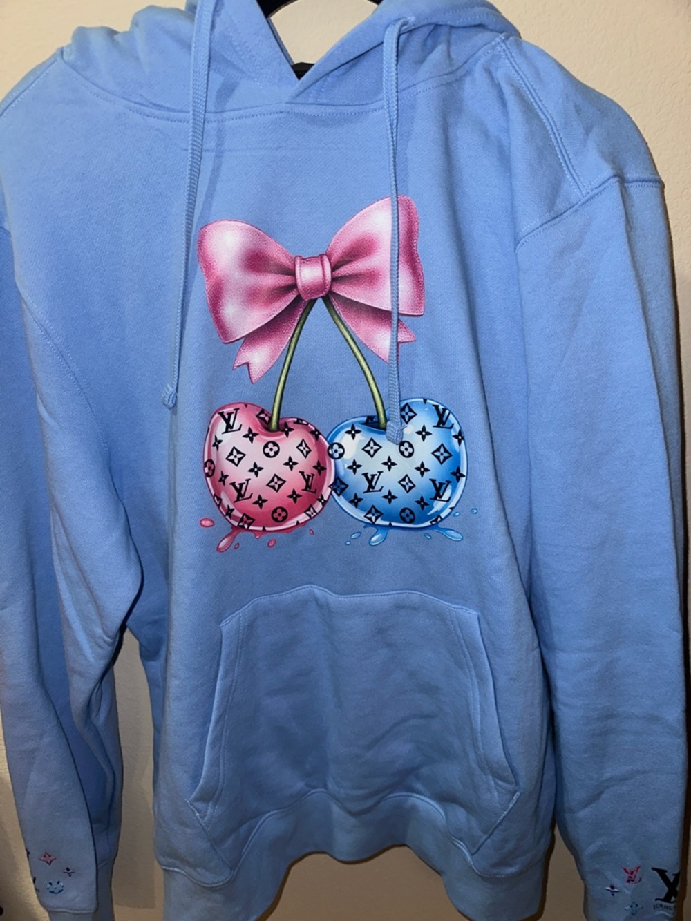 Solid Light Blue Sweatshirt Sleeve with Black Louis Vuitton Logo
